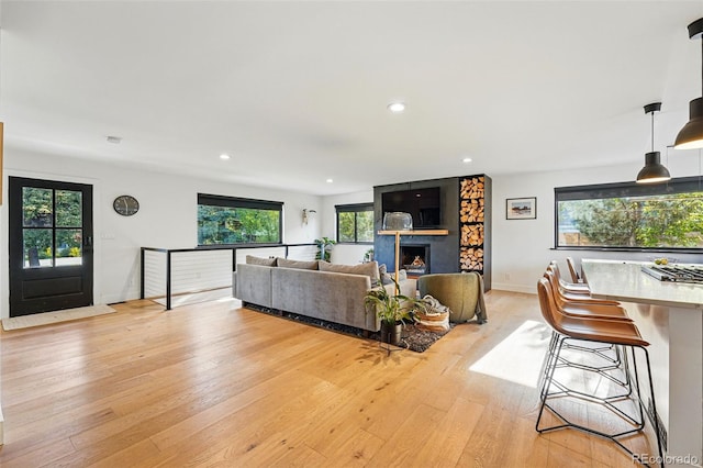 1801 Redwood Ave, Boulder, CO 80304 - living room featuring light wood-style flooring, plenty of natural light, recessed lighting, baseboards, and a large fireplace