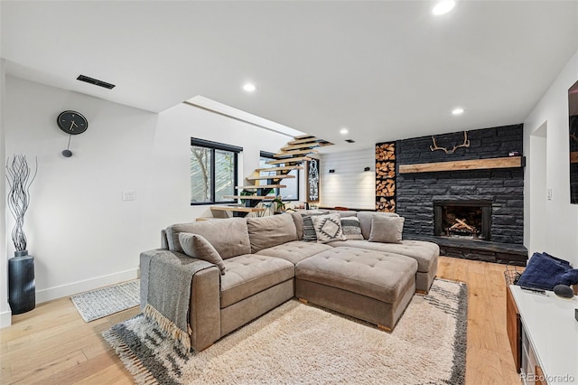 1801 Redwood Ave, Boulder, CO 80304 - living room featuring a fireplace, baseboards, light wood-style floors, stairway, and recessed lighting