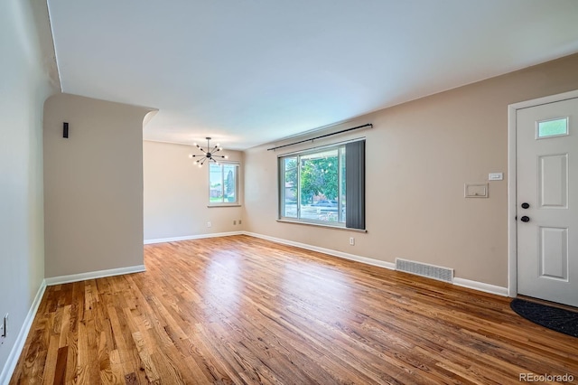 2310 Kenton St, Aurora, CO 80010 - empty room featuring a chandelier and wood finished floors