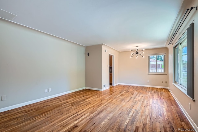 2310 Kenton St, Aurora, CO 80010 - unfurnished room featuring wood finished floors and a chandelier