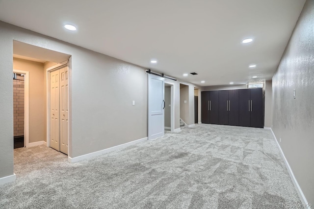 2310 Kenton St, Aurora, CO 80010 - spare room with a barn door, carpet floors, and recessed lighting