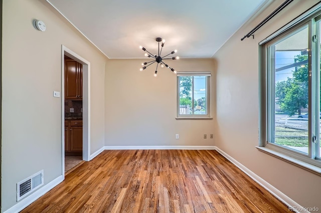 2310 Kenton St, Aurora, CO 80010 - spare room featuring a chandelier, wood finished floors, and a smoke detector