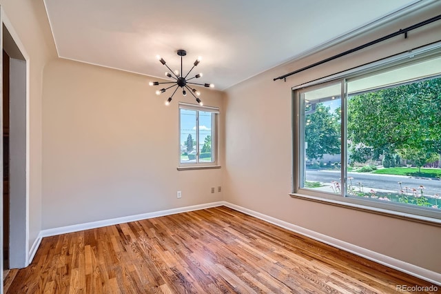 2310 Kenton St, Aurora, CO 80010 - empty room featuring a chandelier and wood finished floors