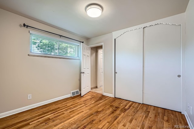 2310 Kenton St, Aurora, CO 80010 - unfurnished bedroom featuring light wood finished floors and a closet