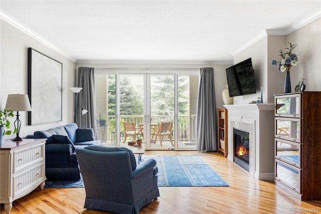 111 S Monroe St Unit B106, Denver, CO 80209 - living area featuring crown molding, a glass covered fireplace, and light wood-type flooring