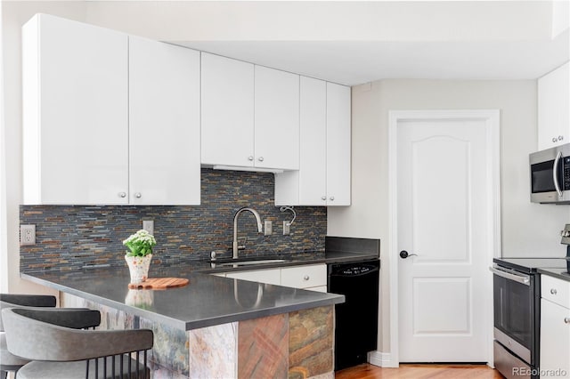 111 S Monroe St Unit B106, Denver, CO 80209 - kitchen featuring stainless steel appliances, dark countertops, a peninsula, and a breakfast bar
