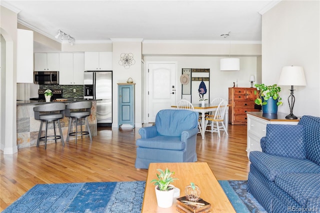 111 S Monroe St Unit B106, Denver, CO 80209 - living area with ornamental molding, light wood-style floors, and arched walkways