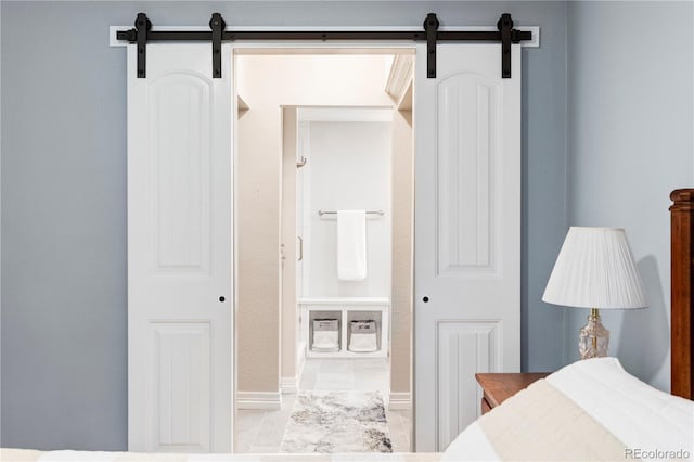 111 S Monroe St Unit B106, Denver, CO 80209 - bedroom with a barn door and baseboards