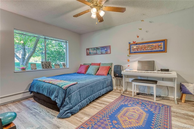 bedroom featuring ceiling fan, a baseboard radiator, wood-type flooring, and a textured ceiling