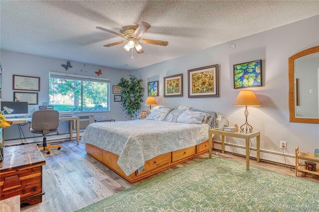 bedroom featuring ceiling fan, a baseboard radiator, wood-type flooring, and a textured ceiling