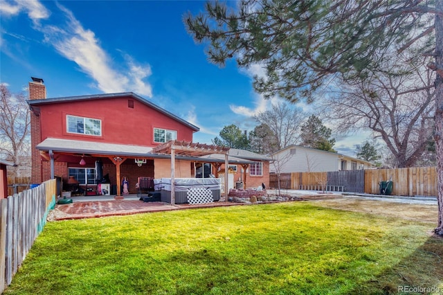 back of property with a hot tub, a patio, a pergola, and a yard