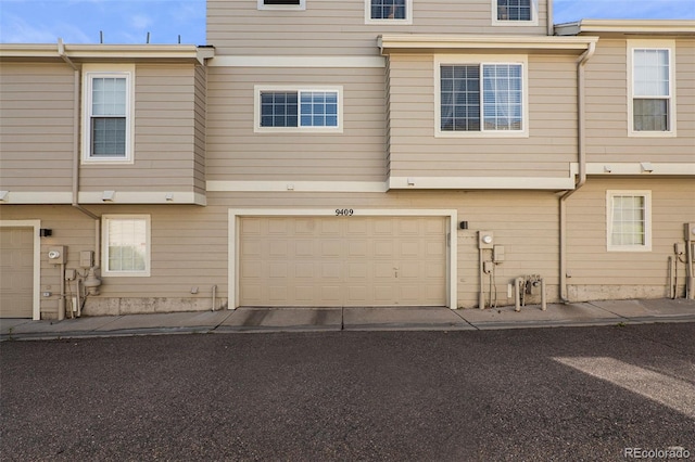 back of property with a garage