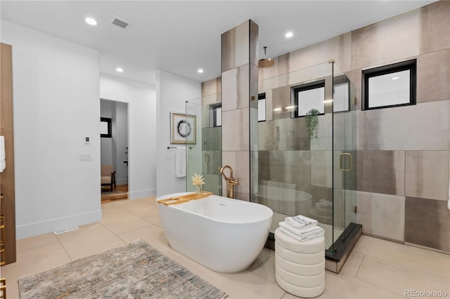 8103 Raphael Ln, Littleton, CO 80125 - bathroom featuring visible vents, recessed lighting, a stall shower, tile patterned floors, and a freestanding tub