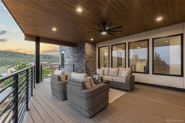 8103 Raphael Ln, Littleton, CO 80125 - deck at dusk with outdoor lounge area and a ceiling fan