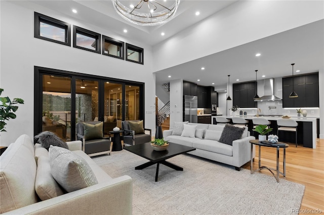 8103 Raphael Ln, Littleton, CO 80125 - living area featuring a chandelier, light wood-style flooring, a high ceiling, and recessed lighting