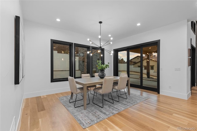 8103 Raphael Ln, Littleton, CO 80125 - dining space featuring a chandelier, baseboards, light wood-type flooring, and recessed lighting