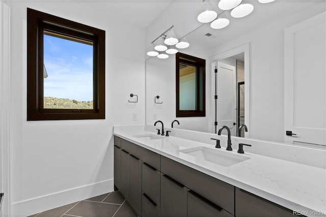 8103 Raphael Ln, Littleton, CO 80125 - bathroom with a sink, tile patterned flooring, double vanity, and visible vents