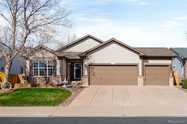 single story home with a garage, a front lawn, fence, and driveway