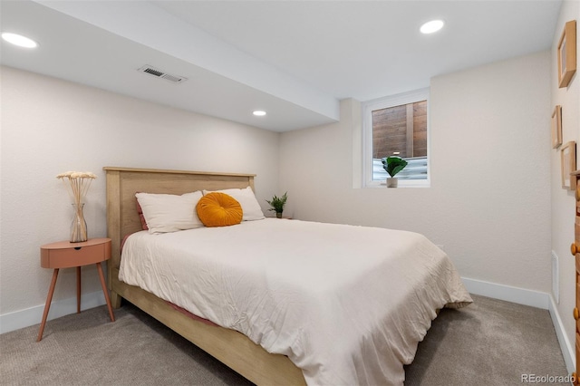 carpeted bedroom featuring baseboards, visible vents, and recessed lighting