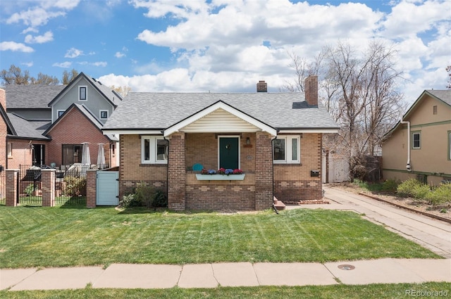 bungalow featuring a chimney, brick siding, fence, and a front yard