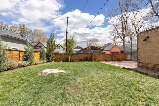 view of yard with a fenced backyard and a residential view