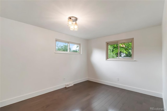 6581 E Heritage Pl, Englewood, CO 80111 - spare room with dark wood-type flooring and a chandelier