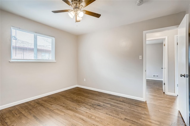 8623 W 54th Pl, Arvada, CO 80002 - unfurnished room with wood finished floors, a ceiling fan, baseboards, and a smoke detector