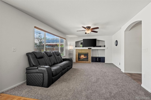 12961 Monaco Way, Thornton, CO 80602 - carpeted living area with ceiling fan and a tiled fireplace