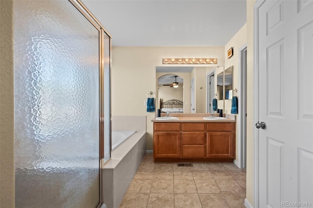 12961 Monaco Way, Thornton, CO 80602 - full bath with a bath, a stall shower, double vanity, ceiling fan, and tile patterned flooring