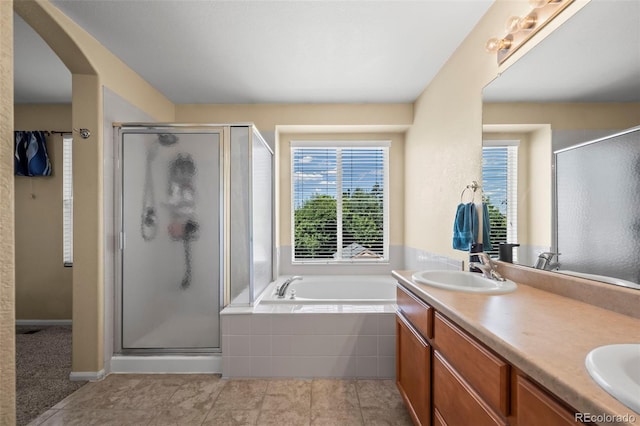 12961 Monaco Way, Thornton, CO 80602 - bathroom featuring a stall shower, a bath, double vanity, and tile patterned flooring