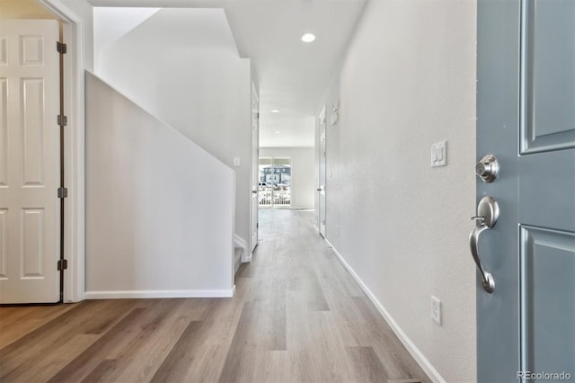 hallway with light hardwood / wood-style floors