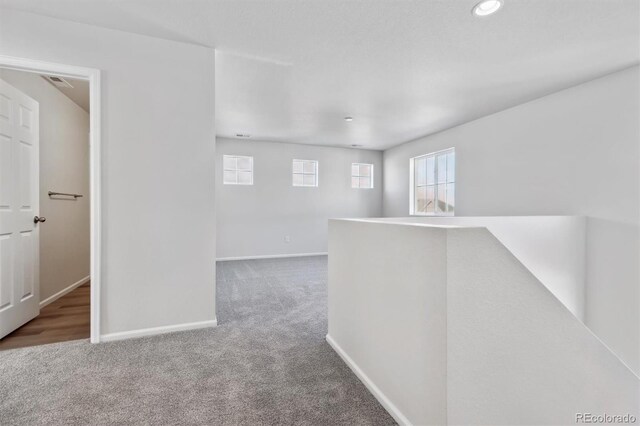 hallway with carpet floors