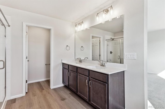 bathroom with vanity, hardwood / wood-style floors, and an enclosed shower