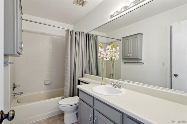 bathroom with visible vents, shower / bathtub combination with curtain, toilet, vanity, and tile patterned flooring