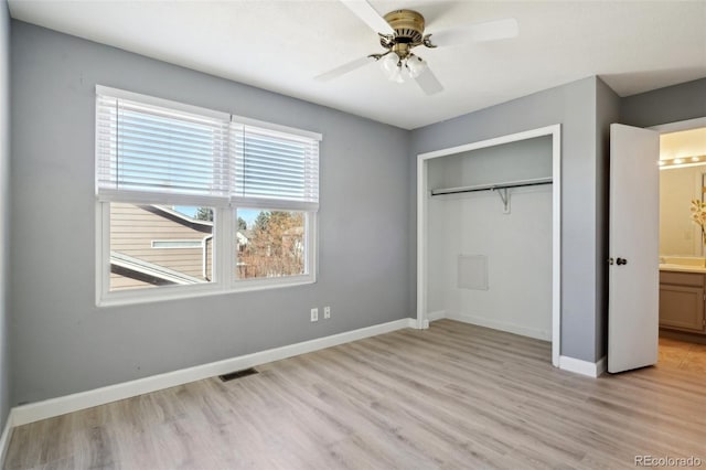 unfurnished bedroom with light wood finished floors, a closet, visible vents, ceiling fan, and baseboards