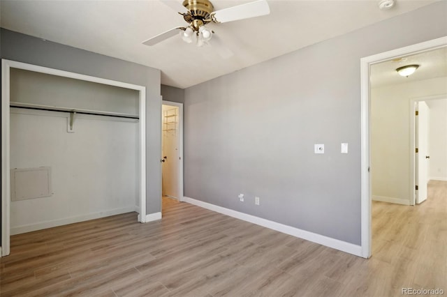 unfurnished bedroom featuring light wood-type flooring, baseboards, and a closet