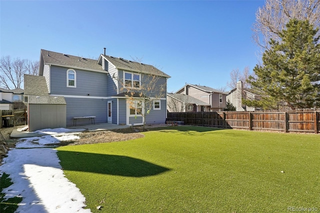 rear view of house with fence, a patio, and a yard