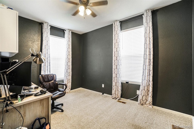 home office featuring carpet floors, a wealth of natural light, and ceiling fan