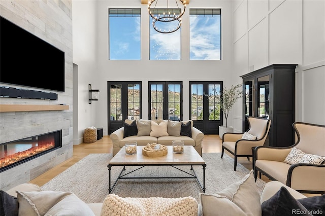 living room with a large fireplace, a high ceiling, and a wealth of natural light