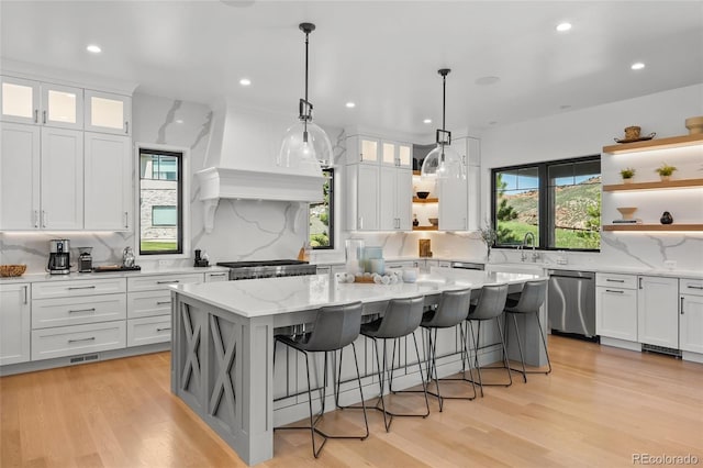 kitchen featuring stainless steel dishwasher, open shelves, and tasteful backsplash