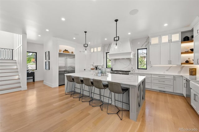 kitchen with stainless steel built in fridge, tasteful backsplash, open shelves, and recessed lighting