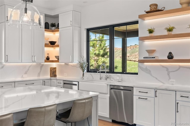 kitchen featuring a sink, a healthy amount of sunlight, open shelves, and dishwasher