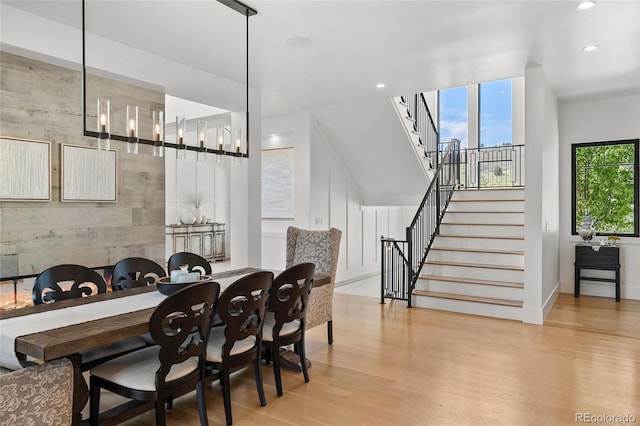 dining space with stairway, baseboards, recessed lighting, and wood finished floors