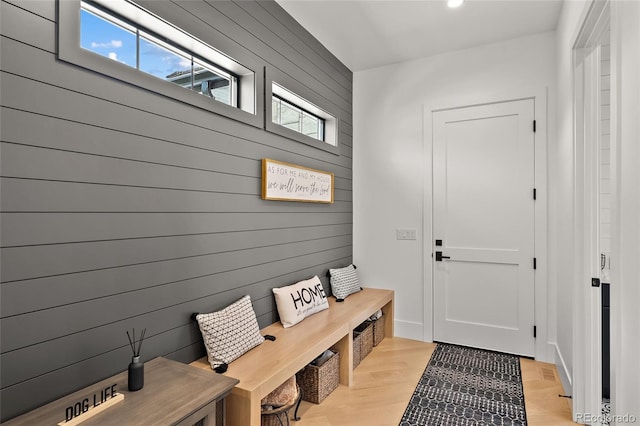 mudroom featuring recessed lighting, wood walls, and light wood-type flooring
