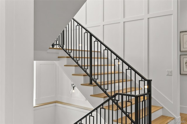 stairway featuring baseboards and wood finished floors