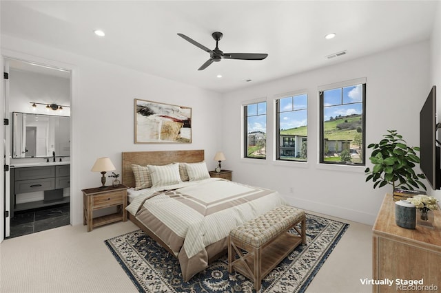 bedroom with a sink, recessed lighting, ensuite bath, and visible vents