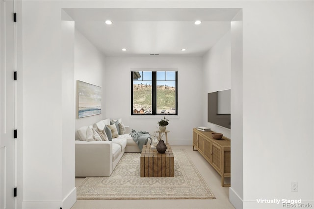 living area with baseboards and recessed lighting