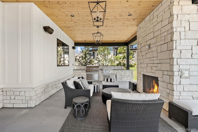 view of patio featuring grilling area, exterior kitchen, and an outdoor living space with a fireplace