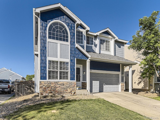 9832 Kenton Cir, Commerce City, CO 80022 - view of front of house featuring stone siding, an attached garage, and concrete driveway