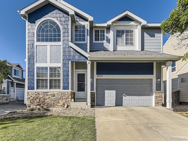 9832 Kenton Cir, Commerce City, CO 80022 - view of front of home featuring stone siding, an attached garage, concrete driveway, a front yard, and a shingled roof
